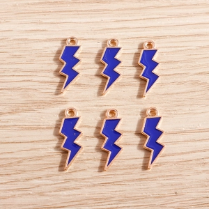 Detailed view of blue enamel lightning pendants with rose gold edges for DIY jewelry