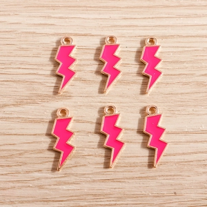 Detailed view of pink enamel lightning bolt charms with gold plating for DIY jewelry making