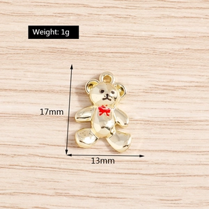 Detail view of gold bear pendant showing dimensions 17mm x 13mm and 1g weight specs