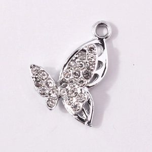 Detailed macro view of silver butterfly pendant with crystals and hollow design