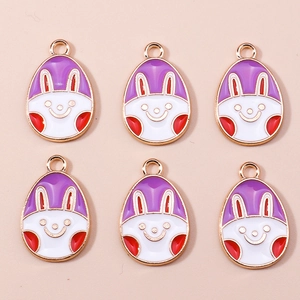 Detail of colorful Easter bunny enamel charms with golden metal edges for DIY crafts