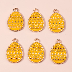 Detail of yellow Easter egg pendants with wave patterns and rose gold metal edges