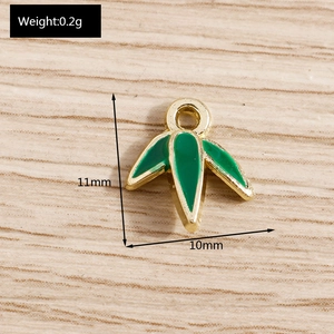Detail view of 11x10mm green enamel bamboo leaf pendant with gold metal edges