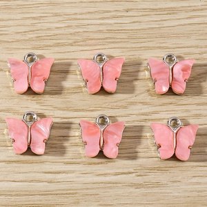 Set of six pink marble textured acrylic butterfly charms with silver metal alloy frames
