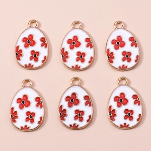 Detail of 6 Easter egg alloy charms with white enamel and red flower patterns