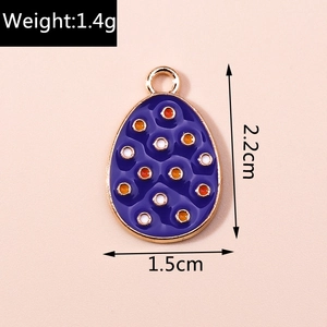 Detail view of purple enamel egg pendant with gold trim showing 2.2cm height and 1.5cm width