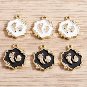 Octagonal alloy handprint and footprint pendants with gold accents and enamel finish