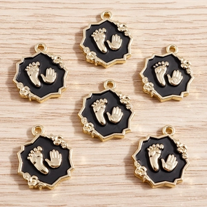 Golden alloy baby handprint and footprint charms with black enamel finish for DIY jewelry