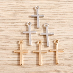 Minimalist gold and silver alloy cross pendants for DIY jewelry making on wood background