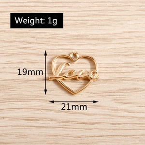 Macro detail of a 19x21mm heart shaped Love pendant in polished gold alloy metal
