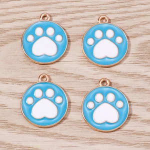 Set of 4 gold-plated alloy pendants with blue enamel flower and white paw print pattern