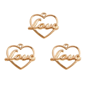 Three gold-plated heart-shaped LOVE pendants for DIY jewelry making in a flat layout