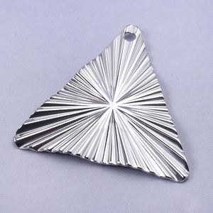 Macro detail of a 304 stainless steel triangle pendant with radial vintage texture