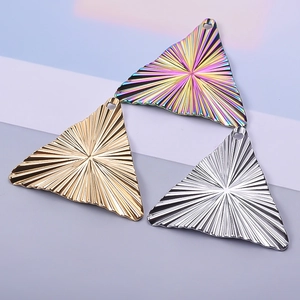 Macro detail of striped 18k gold and iridescent triangle pendants for jewelry making