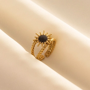 Golden sunburst ring in 304 stainless steel with black stone on white fabric