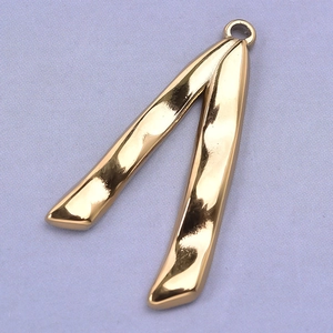 Macro view of a 304 stainless steel V-shaped pendant with a hammered gold texture
