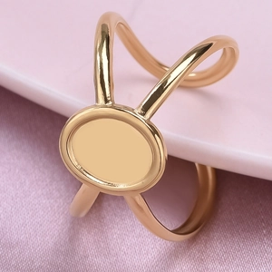 Detailed macro view of an irregular gold stainless steel ring on pink silk fabric