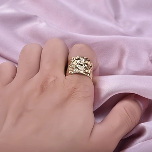 Golden wide stainless steel ring featuring irregular lava texture and vintage design style