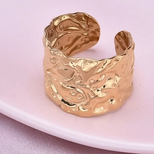 Close-up of golden irregular lava texture on 304 stainless steel adjustable open ring