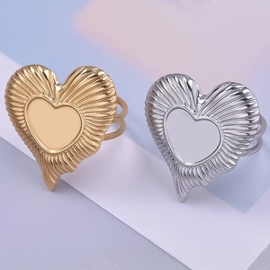Detail of 18K gold and silver heart rings with sunburst texture and dual-band style