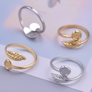 Detailed macro view of 18K gold and silver leaf-shaped adjustable stainless steel rings