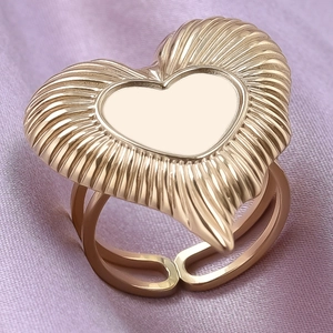 Macro shot of gold 304 stainless steel heart ring with radial texture and adjustable band