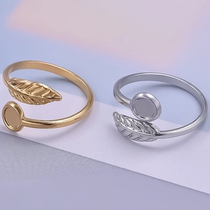 Macro shot of 18K gold and silver leaf feather rings with polished adjustable bands