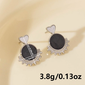 Macro shot of 304 stainless steel heart earrings with black round and fan detail