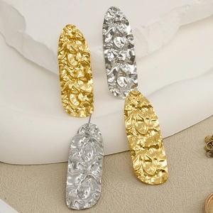 Detail of 304 stainless steel earrings with irregular hammered texture in gold and silver
