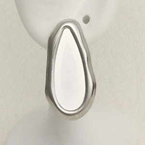 Macro detail of irregular 304 stainless steel stud earrings with liquid metal mirror finish