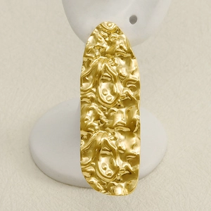 Irregular textured gold 304 stainless steel long drop earrings for women on a display stand
