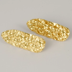 Close-up of long oval 304 stainless steel earrings with irregular lava texture finish