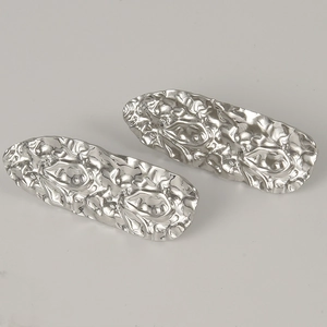 Detail shot of irregular pleated 304 stainless steel earrings with liquid metal texture