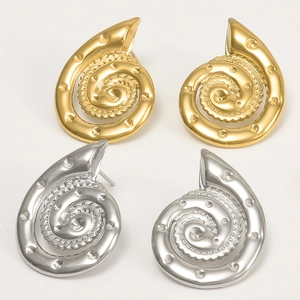 Dettaglio macro di orecchini a conchiglia in acciaio inossidabile finitura oro e argento