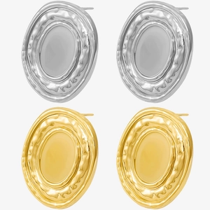 Detailed macro view of oval stud earrings featuring unique hammered gold and silver texture