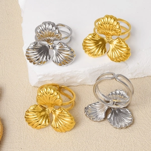 Macro detail of 304 stainless steel triple leaf adjustable rings in gold and silver