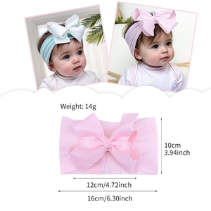 Soft nylon baby headband with large grosgrain bow and size specs in mint green