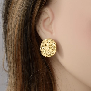 Vintage 304 stainless steel gold oval earrings with hammered texture on female model