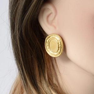 Vintage oval gold hammered earrings made of 304 stainless steel shown on model