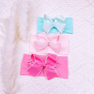 Three-piece set of soft elastic baby headbands with large scalloped edge ribbon bows