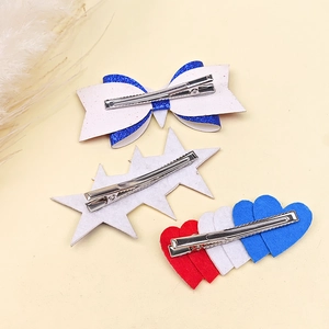 Independence Day hair clip set with glitter bow, star and heart designs on a soft background