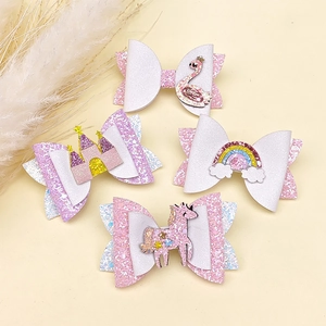 Détail de barrettes pailletées pour filles avec motifs cygne, château et arc-en-ciel