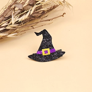 Close-up of Halloween witch hat hair clip with black sequins and purple ribbon detail