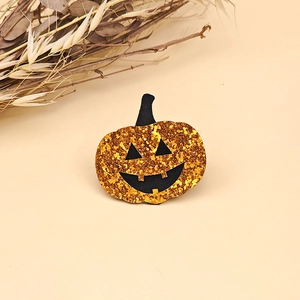 Detailed view of orange sequin pumpkin hair clip with festive Jack-O-Lantern face