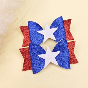 Detail of glitter American flag hair clips with red, blue, and white star patterns