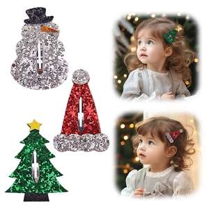 Detailed view of glitter Christmas hair clips set with snowman and tree shapes