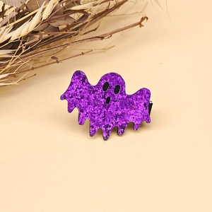 Detail of purple sequin ghost hair clip for Halloween parties on a warm background