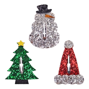 Detail of glitter Christmas hair clips set with snowman, tree and hat shapes on BB clips