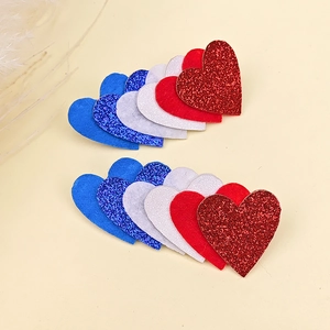 DIY Independence Day heart patches with glitter and felt textures in red, white, and blue