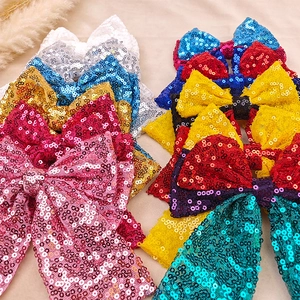 Close-up of colorful sequin bow hair clips for girls in various sparkling shades